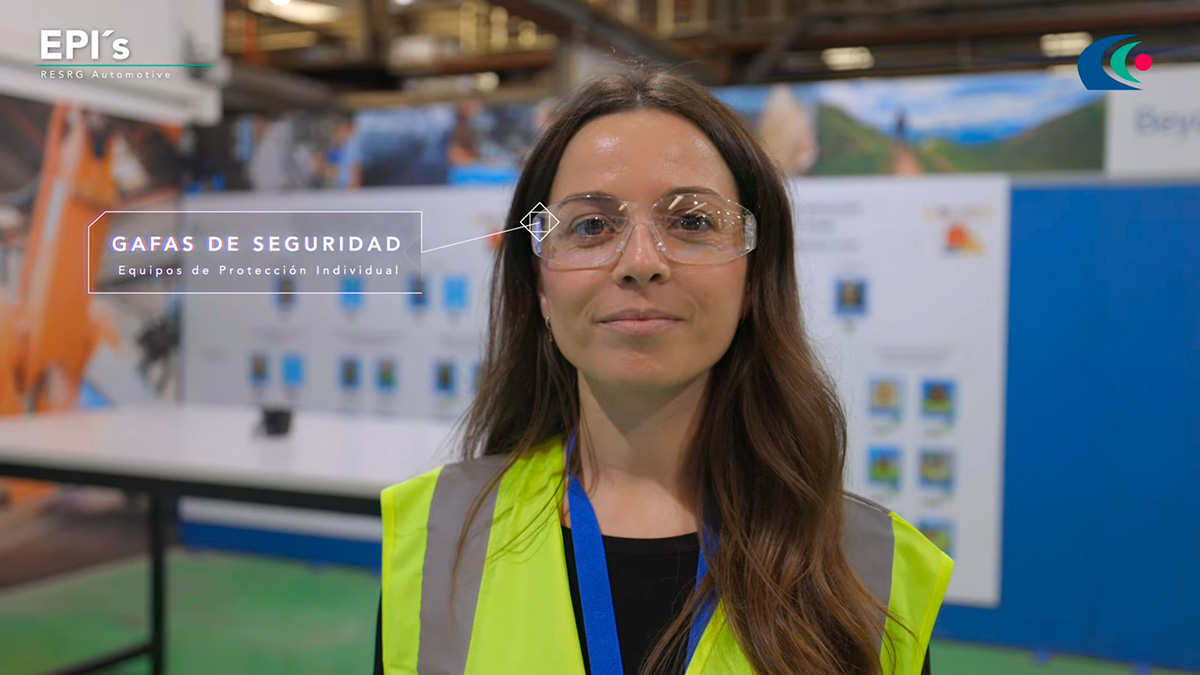 Operaria con gafas y equipo de protección individual durante un vídeo industrial en fábrica en Valencia